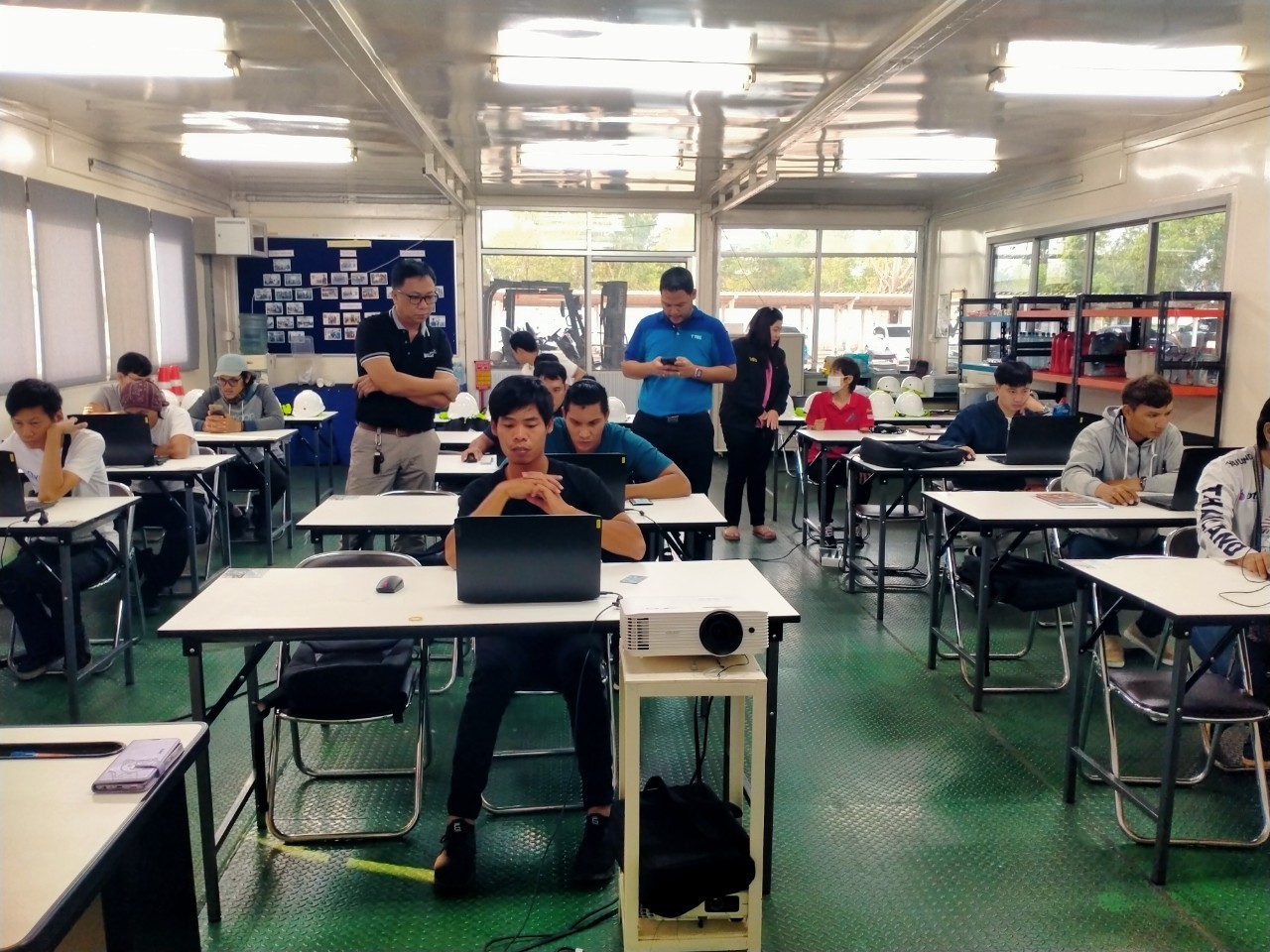 Trainees studying with laptops in the A.N.I. training classroom
