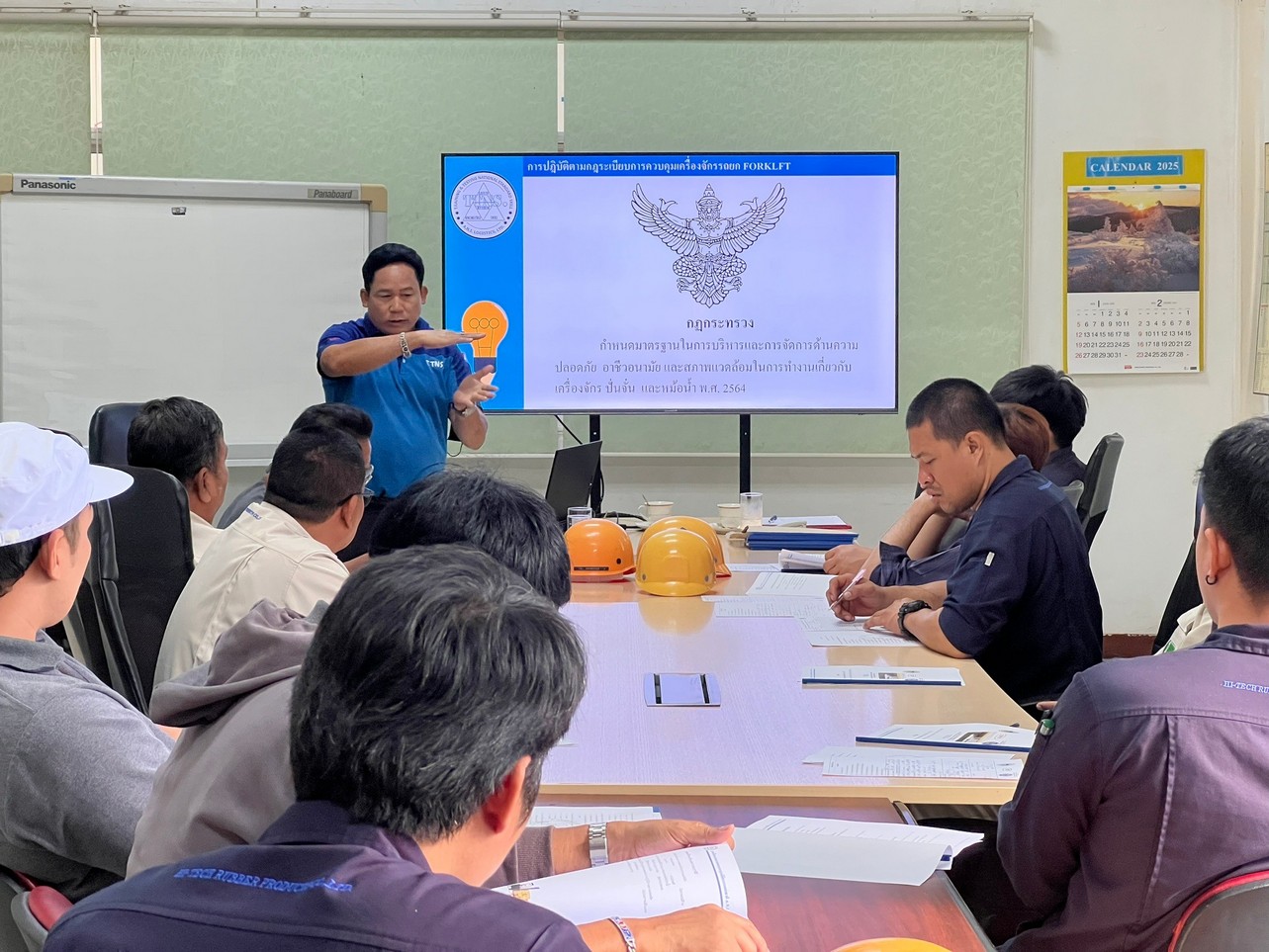 Instructor presenting to trainees in the A.N.I. meeting room
