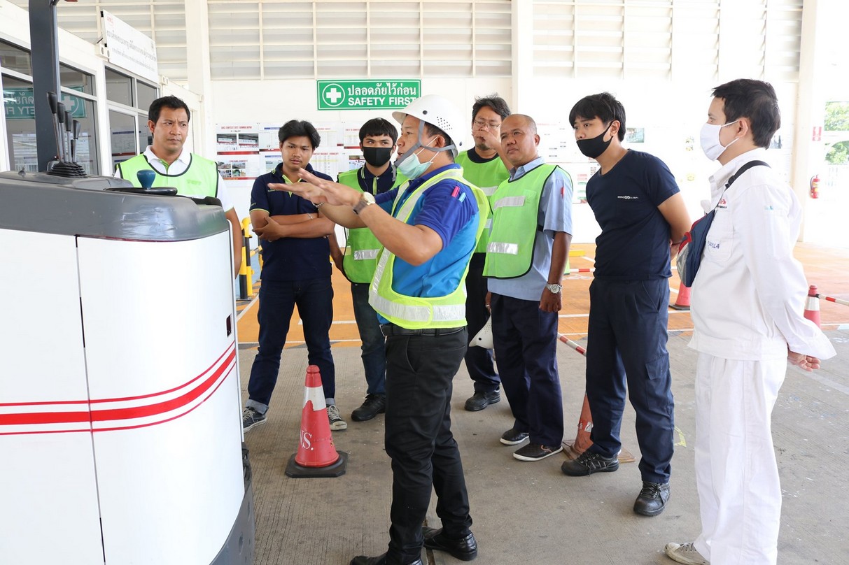 Instructor leading a group discussion with forklift trainees