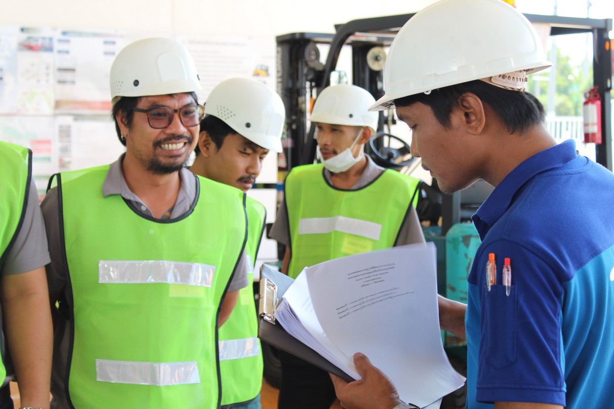 Instructor explaining forklift operation during practical training